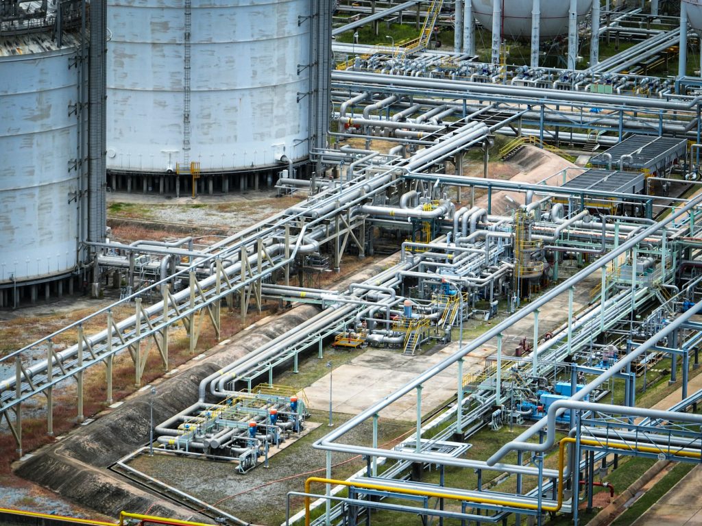 Industrial oil refinery and petrochemical plant with extensive steel pipelines and gas storage