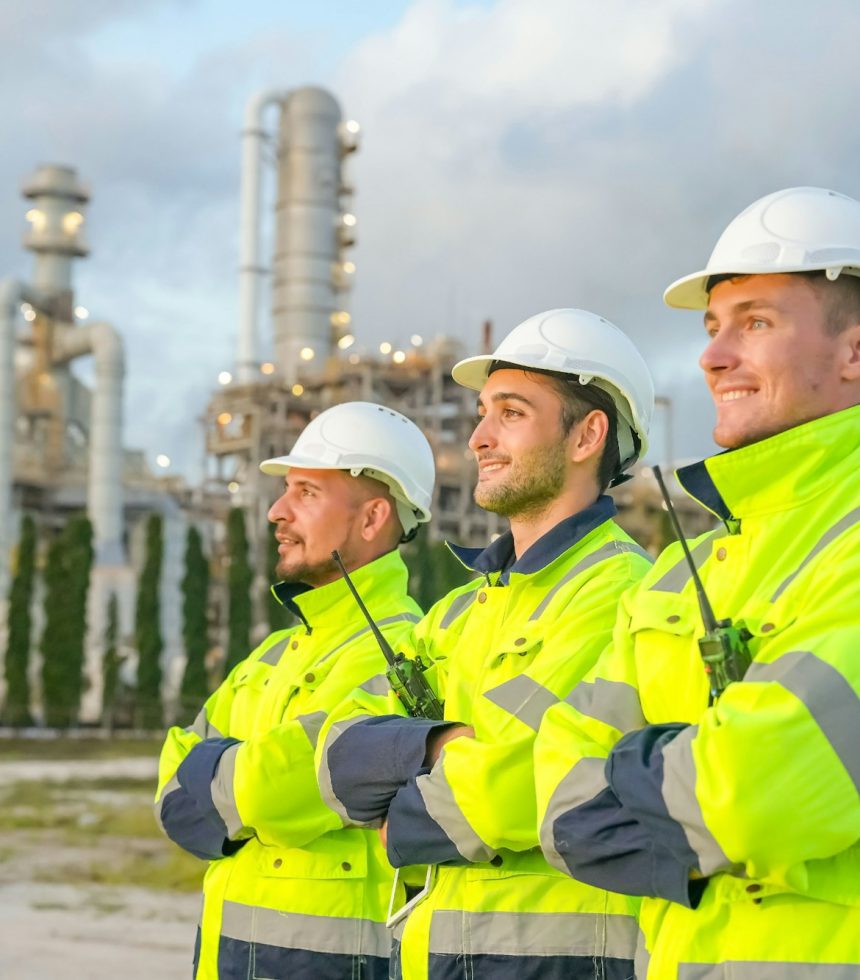 Refinery industry engineer are working and discussing at front oil and gas industrial factory,